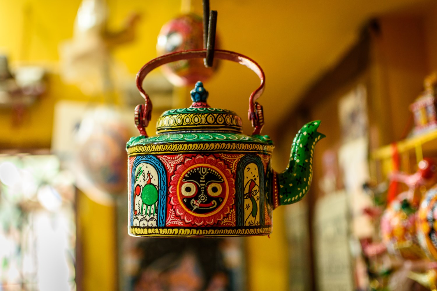 Vibrant Indian teapot with traditional artwork